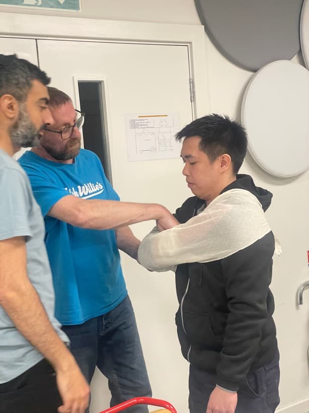 Delegates practising a bandage in pairs